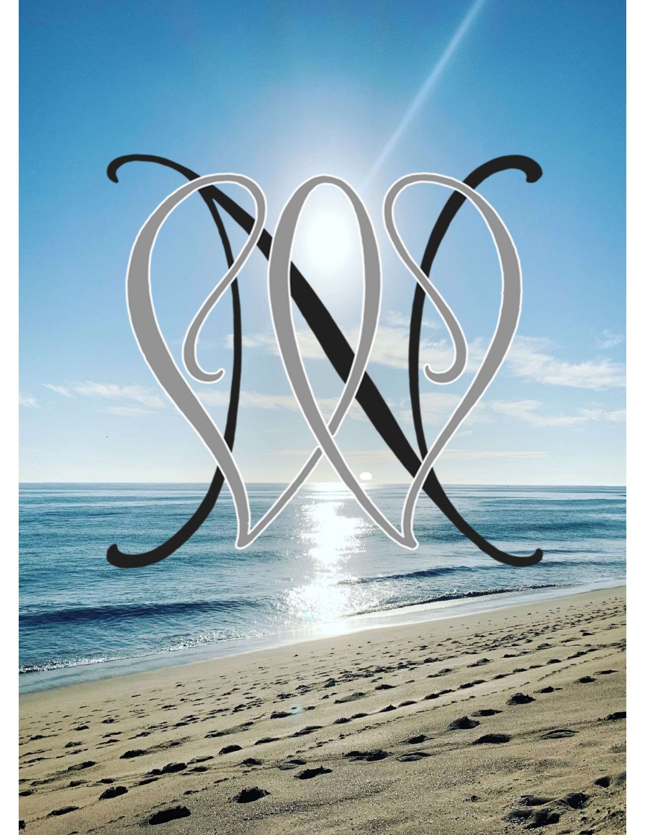 Modern metal sculpture on a beach reflecting sunlight.